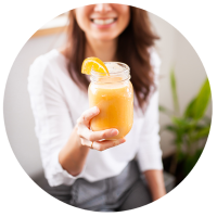 Woman holding smoothie in glass jar