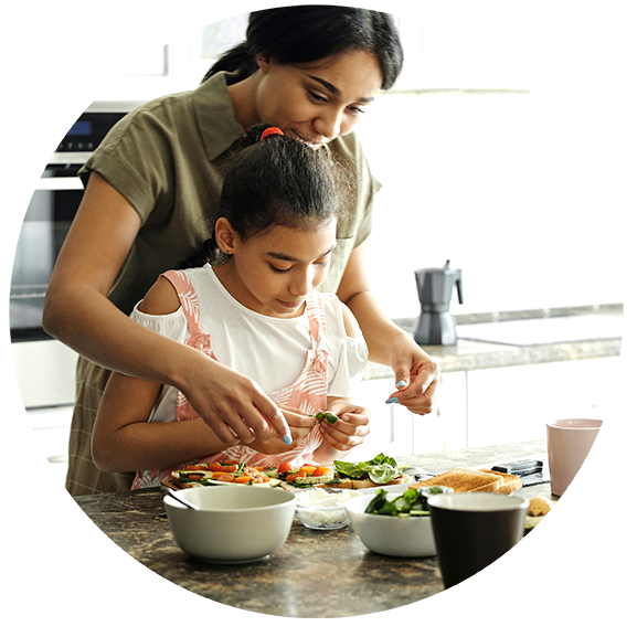 Mother and daughter preparing food